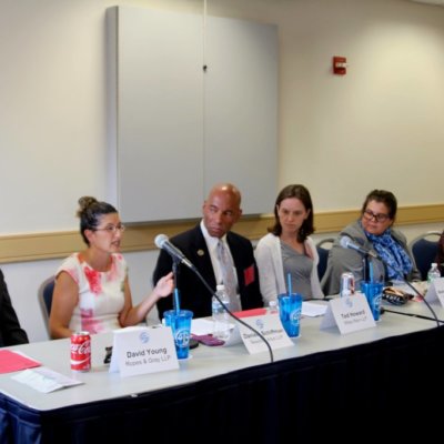 Photo: Poverty-law Panel - 5 Panelists + Moderator Seated At Table