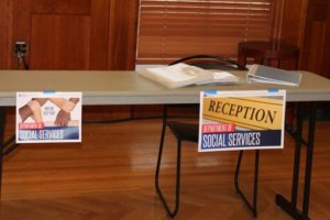 Social Services signs on table at poverty simulation