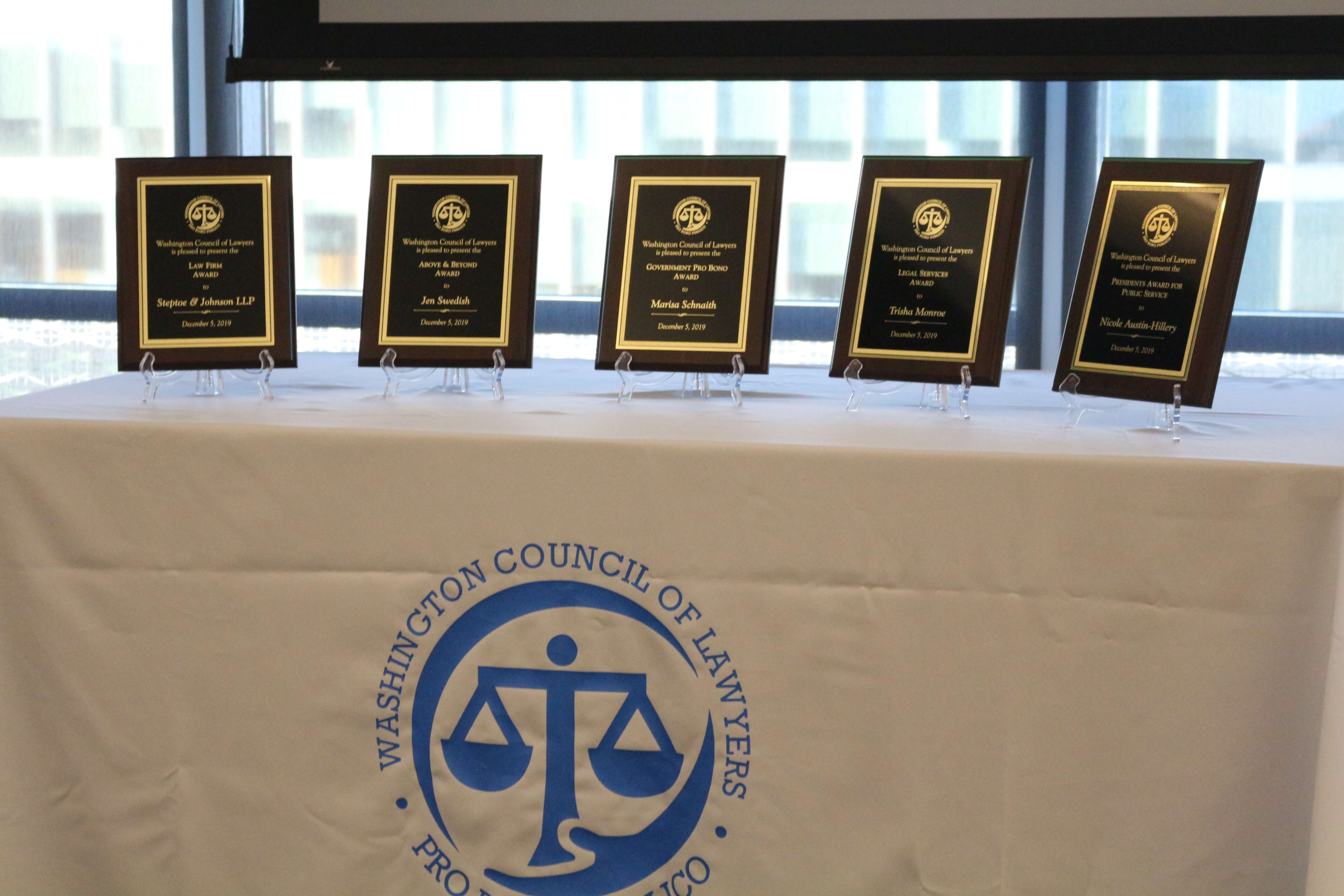 5 award plaques on a table